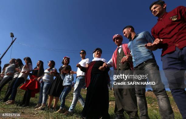 Iraqis dance during a ceremony celebrating the Yazidi New Year on April 19 in the town of Bashiqa, some 20 kilometres north east of Mosul.