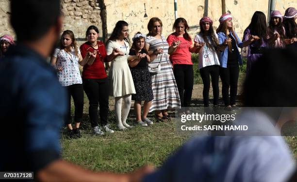 Iraqis dance during a ceremony celebrating the Yazidi New Year on April 19 in the town of Bashiqa, some 20 kilometres north east of Mosul.