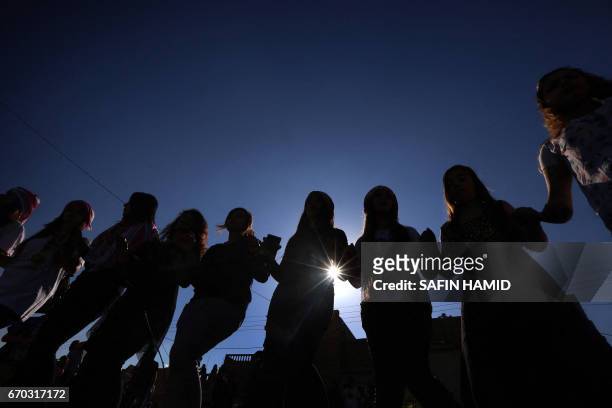 Iraqis dance during a ceremony celebrating the Yazidi New Year on April 19 in the town of Bashiqa, some 20 kilometres north east of Mosul.