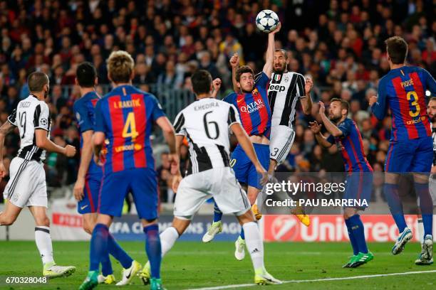 Barcelona's midfielder Sergi Roberto touches the ball with his hand past Juventus' defender Giorgio Chiellini during the UEFA Champions League...