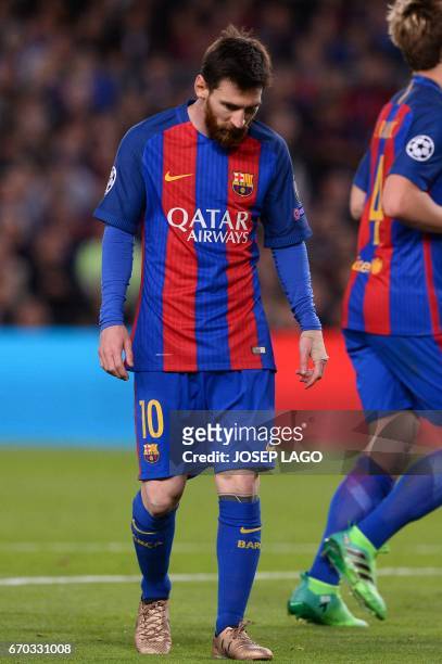 Barcelona's Argentinian forward Lionel Messi looks down as he walks on the pitch during the UEFA Champions League quarter-final second leg football...
