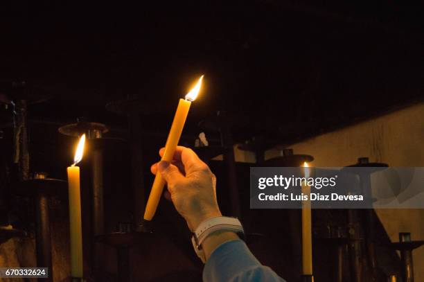 lighting candles in memory of the dead - easter church stock-fotos und bilder
