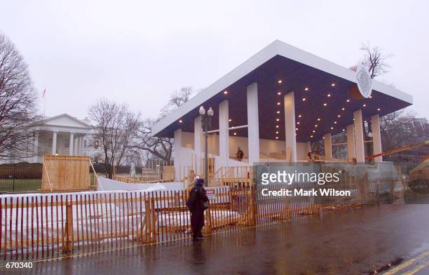 Woman walks past the presidential reviewing stand on Pennsylvania Ave. In front of the White House, January 8, 2001 in Washington, DC. After being...
