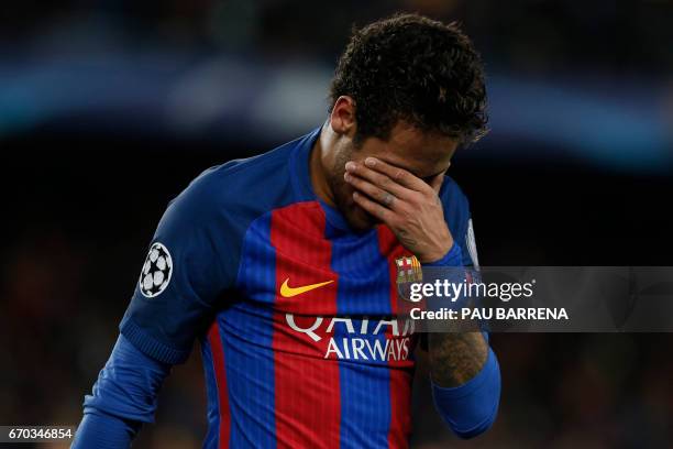 Barcelona's Brazilian forward Neymar reacts to their disqualification by Juventus at the end of the UEFA Champions League quarter-final second leg...