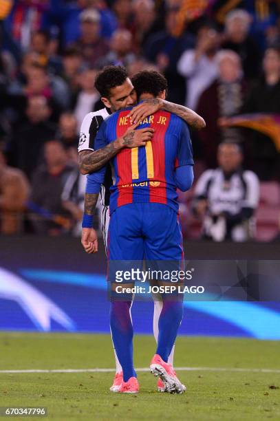 Barcelona's Brazilian forward Neymar is comforted by Juventus' Brazilian defender Dani Alves after their disqualification by Juventus at the end of...