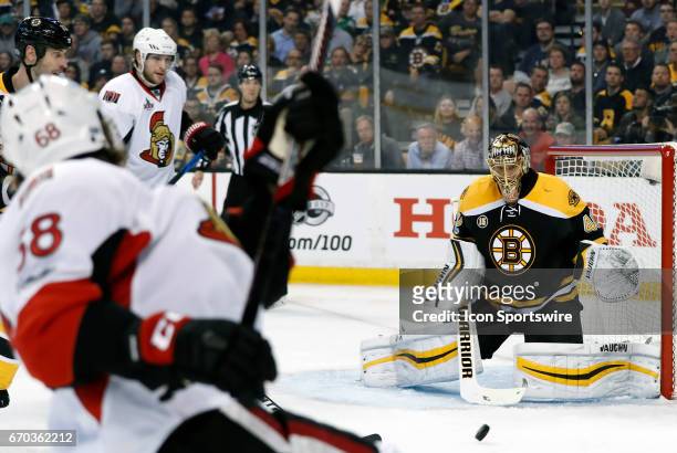 Boston Bruins goalie Tuukka Rask eyes the shot from Ottawa Senators left wing Mike Hoffman during Game 3 of a first round NHL playoff game between...