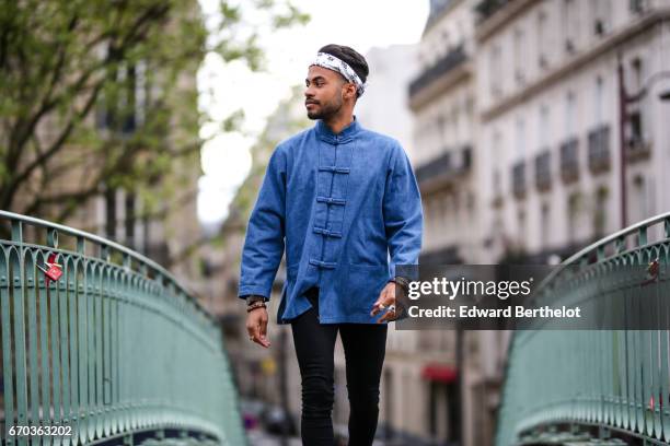 Theo Kimbaloula, fashion blogger, wears a Carubas blue Chinese jacket, a Western Candy bandana, Asos jeans, and Asos boots, on April 16, 2017 in...