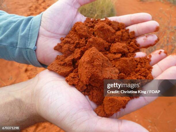 men showing red dirt - uluru rock stock pictures, royalty-free photos & images