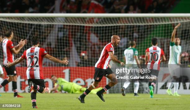 Juan Sebastian Veron of Estudiantes celebrates the opening goal scored by Javier Fabian Toledo of Estudiantes during a group stage match between...