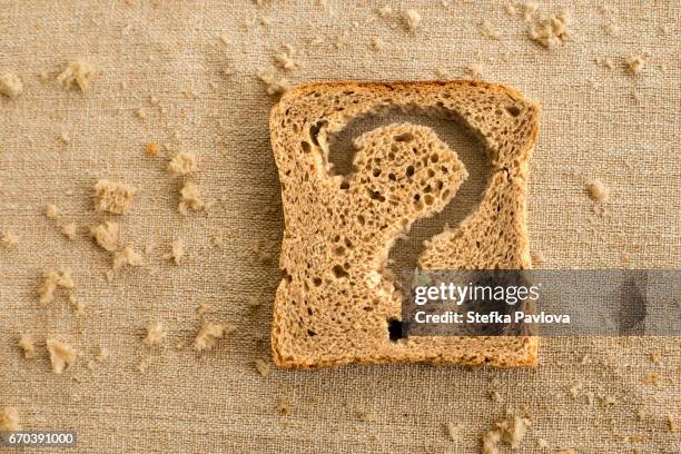 a slice of bread toast with a question mark - pan rallado fotografías e imágenes de stock