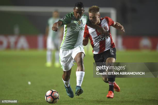 Argentina's Estudiantes de La Plata midfielder Santiago Ascacibar vies for the ball with Colombia's Atletico Nacional midfielder Macnelly Torres...