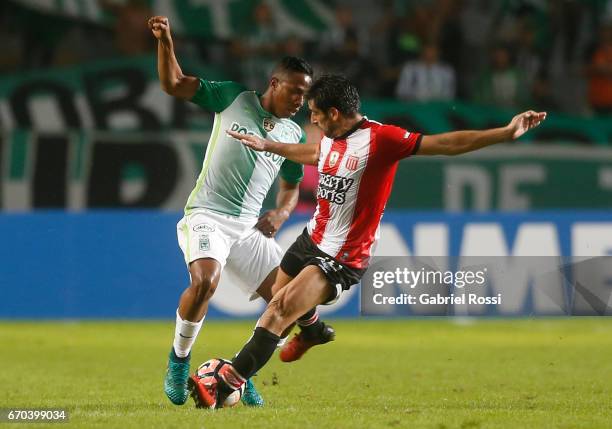 Andres Ibarguen of Atletico Nacional fights for the ball with Rodrigo Brana of Estudiantes during a group stage match between Estudiantes and...