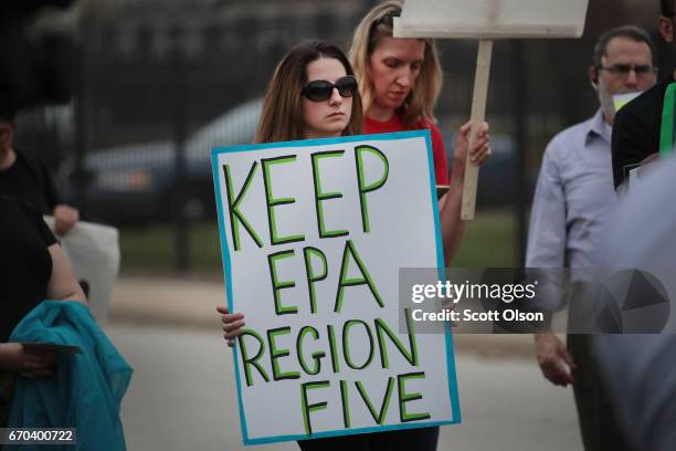 Environmental activists protest outside the Carrie Gosch Elementary School before a visit by U.S. EPA Adminstrator Scott Pruitt on April 19, 2017 in...