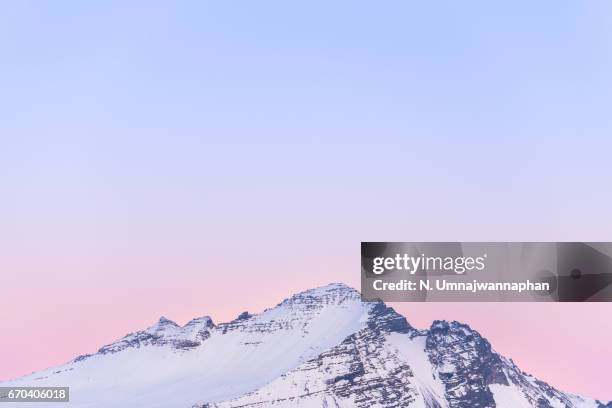 vanilla sky and the snowcapped mountain in iceland during the sunset - snowy mountain peak stock pictures, royalty-free photos & images