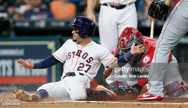 Jose Altuve of the Houston Astros is tagged out by Martin Maldonado of the Los Angeles Angels of Anaheim as he attempted to score on a pitch from JC...