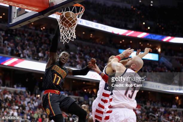 Dennis Schroder of the Atlanta Hawks dunks the ball in front of Marcin Gortat of the Washington Wizards in the second half in Game Two of the Eastern...
