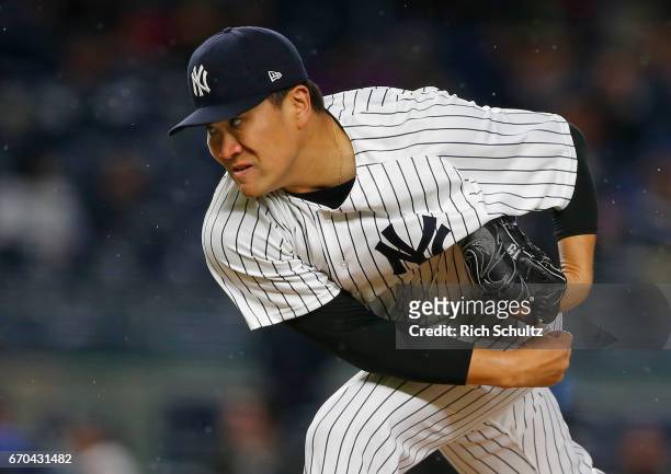 Pitcher Masahiro Tanaka of the New York Yankees delivers a pitch against the Chicago White Sox during the second inning of a game at Yankee Stadium...