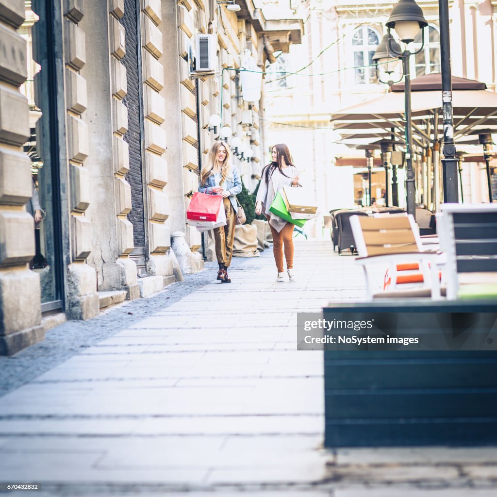 Happy women with shopping bags walking in city. Belgrade, Serbia, Europe