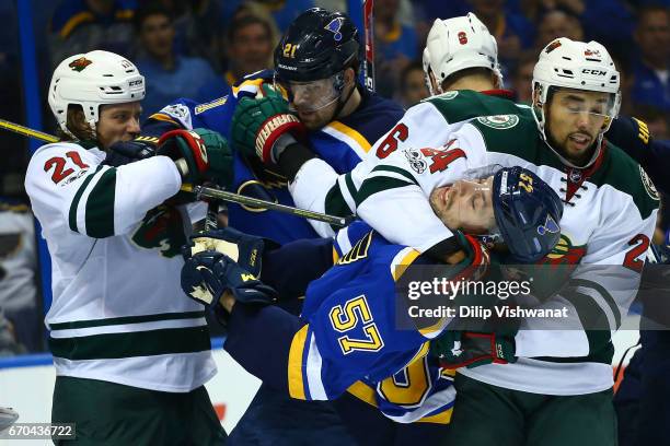 Ryan White of the Minnesota Wild tussles with Patrik Berglund of the St. Louis Blues as Matt Dumba of the Minnesota Wild puts David Perron of the St....