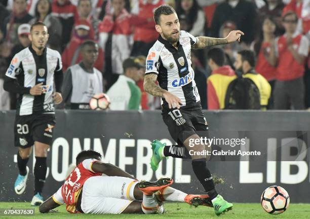 Jose Adolfo Valencia of Santa Fe struggles for the ball with Lucas Lima of Santos during a group stage match between Independiente Santa Fe v Santos...