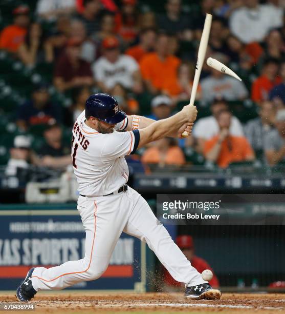 Evan Gattis of the Houston Astros breaks his bat on foul ball off his foot in the eighth inning against the Los Angeles Angels of Anaheim at Minute...