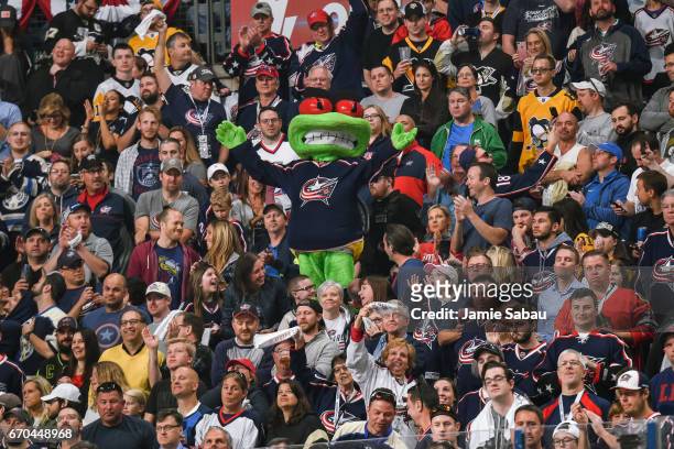 Columbus Blue Jackets mascot Stinger cheers with fans during a game against the Pittsburgh Penguins in Game Four of the Eastern Conference First...