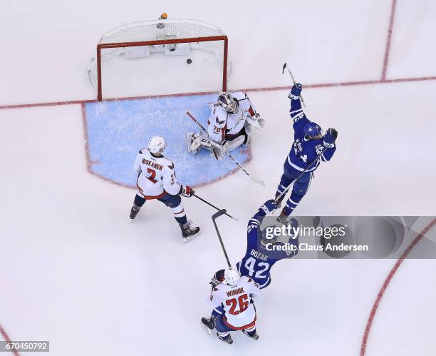 Nazem Kadri and Tyler Bozak of the Toronto Maple Leafs celebrate a goal by teammate James van Riemsdyk against the Washington Capitals in Game Four...