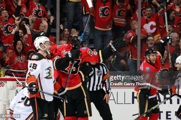 Sean Monahan, Johnny Gaudreau, and teammates of the Calgary Flames celebrate a goal against the Anaheim Ducks during Game Four of the Western...