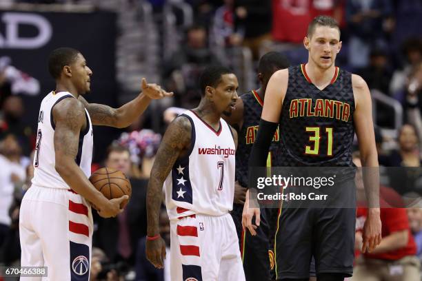 Brandon Jennings celebrates after scroing with Bradley Beal of the Washington Wizards in front of Mike Muscala of the Atlanta Hawks in the second...