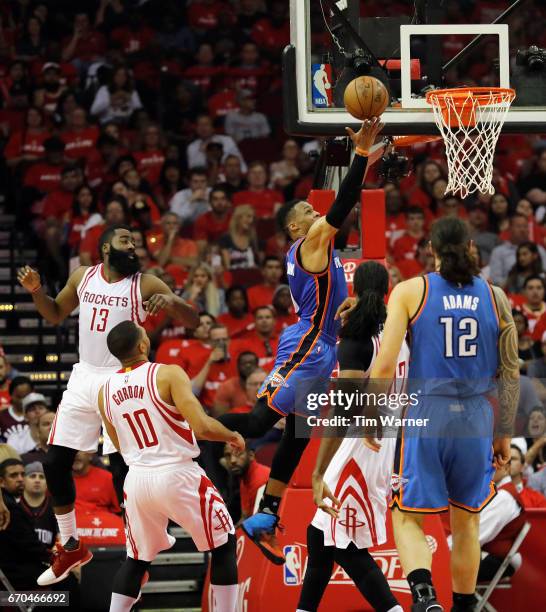 Russell Westbrook of the Oklahoma City Thunder goes up for a layup defended by Nene Hilario of the Houston Rockets and James Harden in the first half...