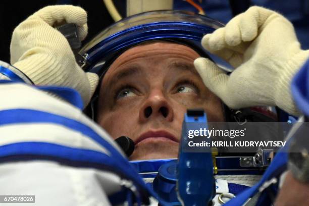 Astronaut Jack David Fischer, a member of the main crew of the 51/52 expedition to the International Space Station , reacts as his space suit is...