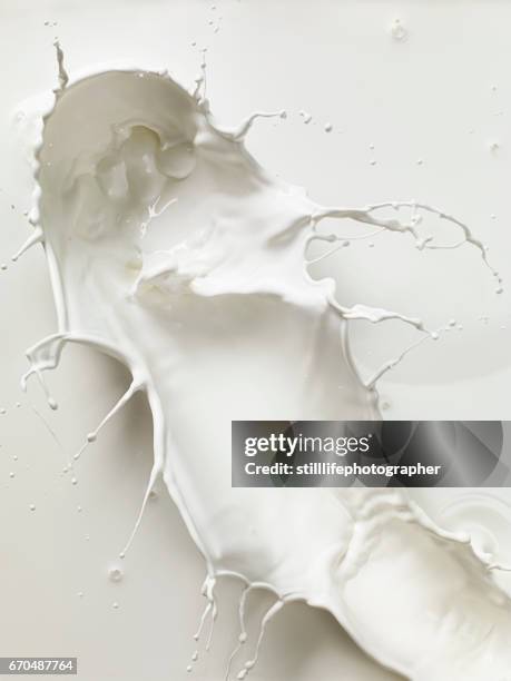 milky splash - milk splashing stock pictures, royalty-free photos & images