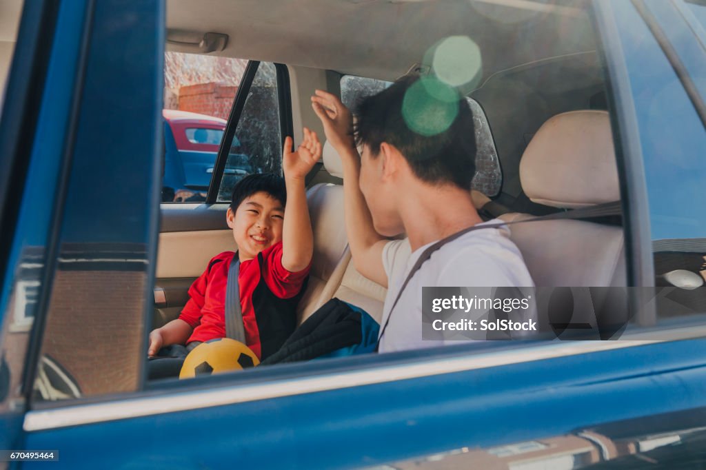 Chinese Kids Laughing in Backseat