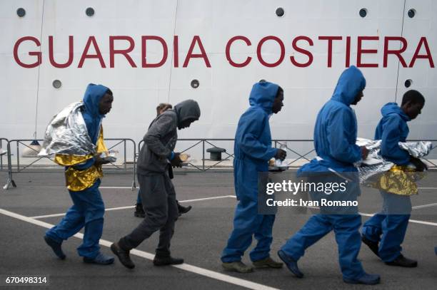 More than 400 migrants rescued in the Sicily Channel from the Italian Coast Guard ship the Gregoretti, rest on board the ship on April 19, 2017 in...