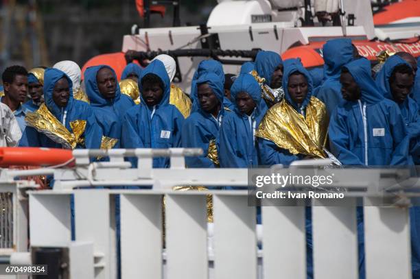 More than 400 migrants rescued in the Sicily Channel from the Italian Coast Guard ship the Gregoretti, rest on board the ship on April 19, 2017 in...