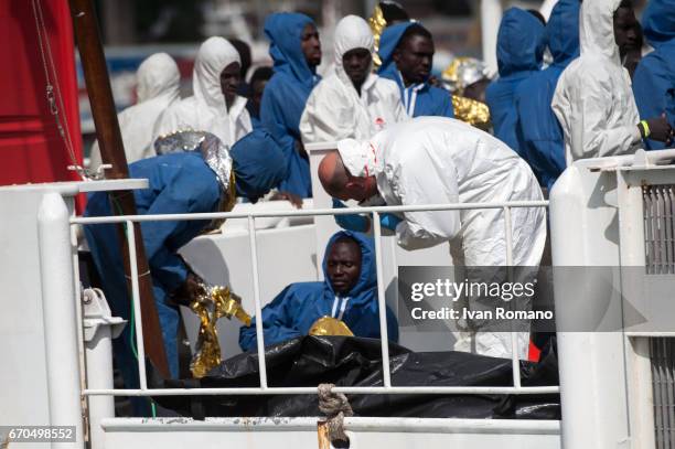 More than 400 migrants rescued in the Sicily Channel from the Italian Coast Guard ship the Gregoretti, rest on board the ship on April 19, 2017 in...