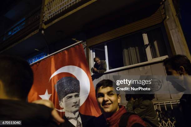 Protesters march through the Besiktas neighborhood of Istanbul on April 19, 2017. People marched in opposition to perceived voting irregularities in...