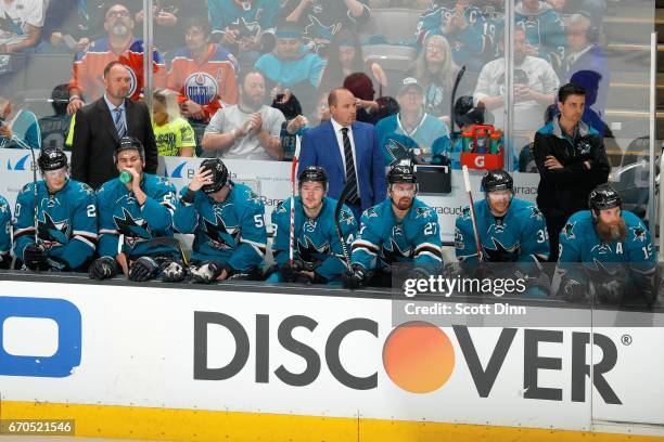 Head Coach, Peter DeBoer, Assistant Coach, Steve Spott and Head Athletic Trainer, Ray Tufts of the San Jose Sharks look during a game against the...