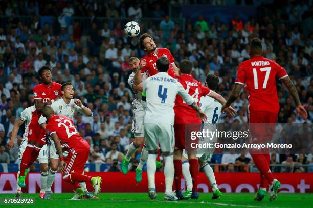Mats Hummels of Bayern Muenchen wins the header after Karim Benzema of Real Madrid CF during the UEFA Champions League Quarter Final second leg match...