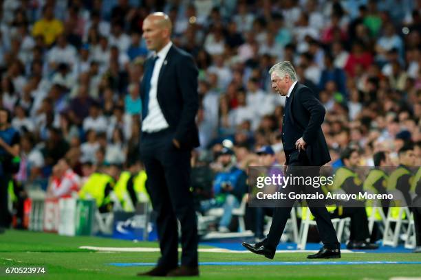 Head coach Carlo Ancelotti of Bayern Muenchen reacts behind head coach Zinedine Zidane of Real Madrid CF during the UEFA Champions League Quarter...