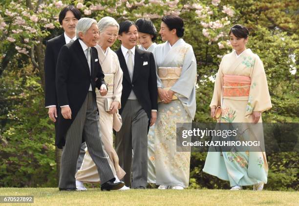 Japan's Emperor Akihito and Empress Michiko with members of the royal family walk to greet guests during the spring garden party at the Akasaka...