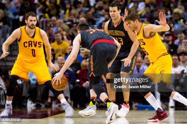 Ryan Kelly of the Atlanta Hawks drives around Kyle Korver of the Cleveland Cavaliers during the first half at Quicken Loans Arena on April 7, 2017 in...