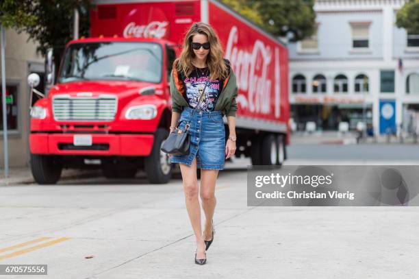 Model and fashion blogger Alexandra Lapp wearing a T-Shirt from ECNTRC with a Karl Lagerfeld look-a-like of Eddie the Head monster of the band Iron...