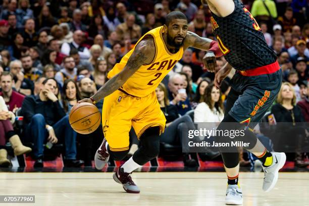 Kyrie Irving of the Cleveland Cavaliers drives around Ryan Kelly of the Atlanta Hawks during the first half at Quicken Loans Arena on April 7, 2017...