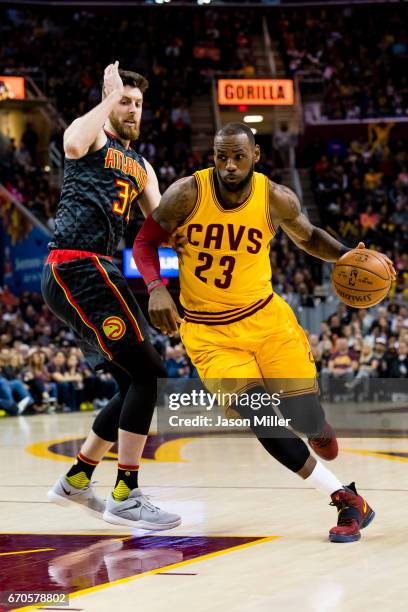 Ryan Kelly of the Atlanta Hawks guards LeBron James of the Cleveland Cavaliers during the first half at Quicken Loans Arena on April 7, 2017 in...