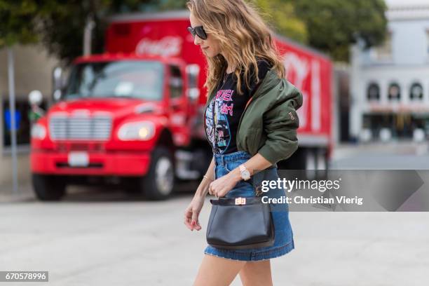 Model and fashion blogger Alexandra Lapp wearing a T-Shirt from ECNTRC with a Karl Lagerfeld look-a-like of Eddie the Head monster of the band Iron...