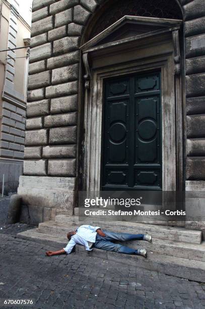 Homeless man sleeps on the street in via dei Fornari near Piazza Venezia on June 22, 2007 in Rome, Italy.