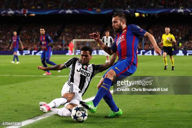 Jordi Alba of FC Barcelona is tackled by Dani Alves of Juventus during the UEFA Champions League Quarter Final second leg match between FC Barcelona...