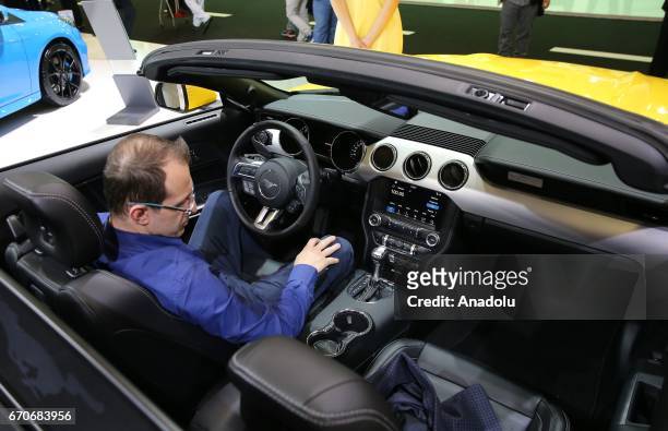 Man inspects Mustang 2.3 Ecoboost during the Istanbul Autoshow 2017 at the TUYAP Fair and Convention Center in Istanbul, Turkey on April 20, 2017.