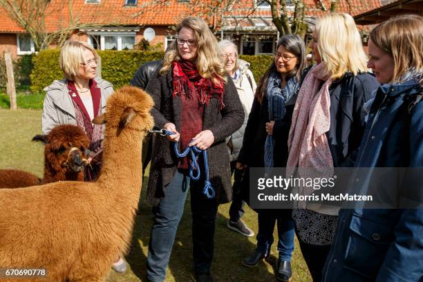 Schleswig-Holstein Families Minister Kristin Alheit and German Families Minister Manuela Schwesig pose for a photo with members of the...